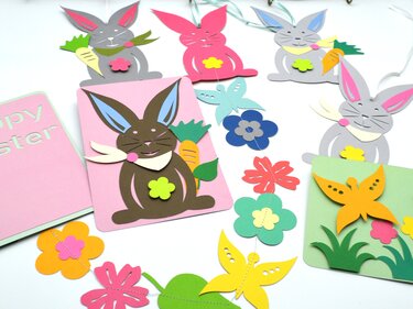 Pastellfarbene, mehrschichtige Papierhasen, Blumen und Schmetterlinge als Anhänger, Karten und Girlande