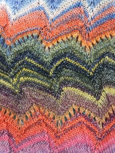 Close-up of chevron ripple stitch in multicolored yarn showing stitch repeat and ridges.