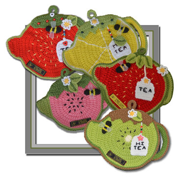 Five crochet teapot-shaped potholders in vibrant fruit designs (strawberry, lemon, watermelon, kiwi) with tea tags, bee and flower appliqués, and hanging loops.