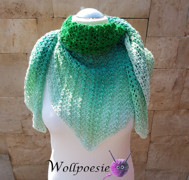 Gehäkeltes Dreieckstuch in Grüntönen mit Farbverlauf, auf einer Schaufensterpuppe drapiert