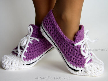 Pair of purple and white crochet lace-up slippers on feet