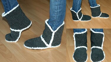 Dunkelgraue gehäkelte Hausschuhe mit weißem Rand, getragen zu Jeans