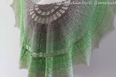 Green and gray ombré crochet lace shawl with a round yoke and openwork patterns