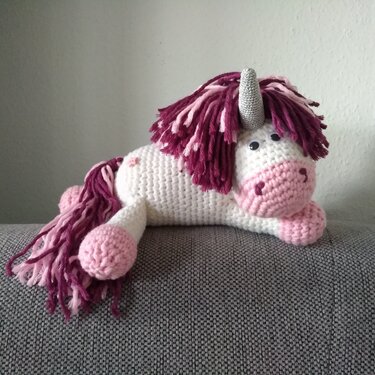 Weiß-rosa gehäkeltes Einhorn-Amigurumi mit dunkelrosa Mähne und silbernem Horn