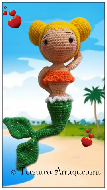 Crocheted amigurumi mermaid doll with yellow hair, orange ruffled top, and green tail on a beach background.