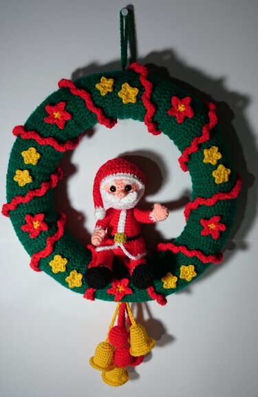 Gehäkelter Weihnachtskranz in Grün mit Weihnachtsmann, Sternen und Glocken