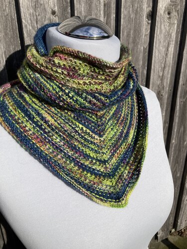 Triangular knitted collar scarf in green, navy and multicolor variegated yarn on a mannequin