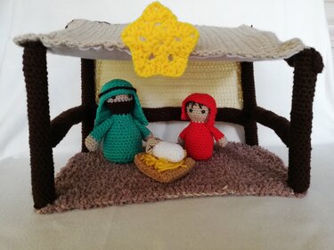 Gehäkelte Krippe mit Dach, gelbem Stern und drei gehäkelten Figuren