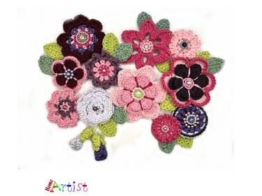 Assorted crocheted flower appliqués with bead centers and small leaves on a white background