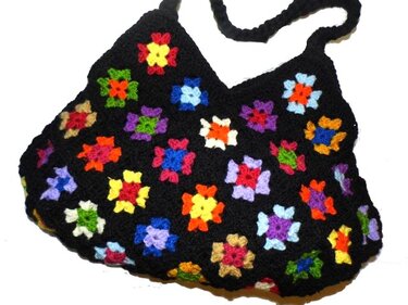 Schwarze gehäkelte Umhängetasche mit bunten Granny-Motiven