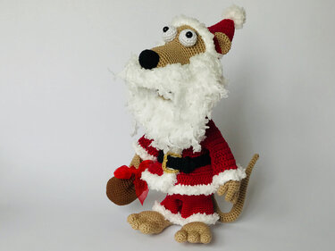 Gehäkelte Amigurumi-Tierfigur in rotem Weihnachtsmannkostüm mit weißem Bart und Geschenksäckchen