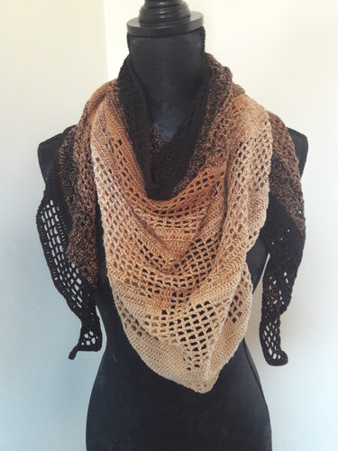 Mannequin wearing a gradient brown to beige lacy crochet triangle shawl