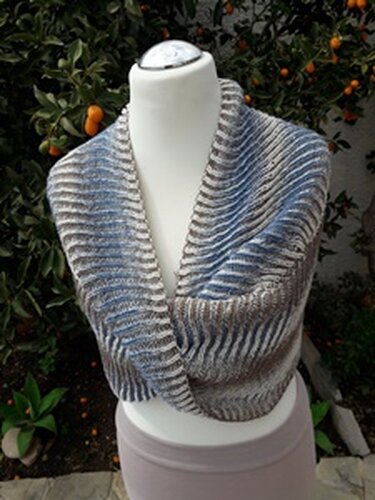Knitted ribbed infinity cowl in blue, gray and beige draped on a white mannequin