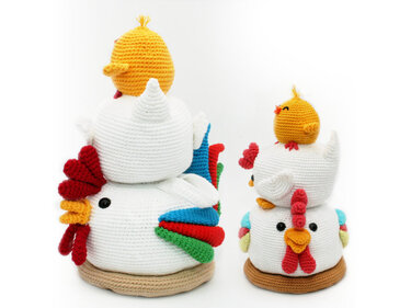 Pair of crochet chicken doorstoppers in two sizes, each topped with a small yellow chick