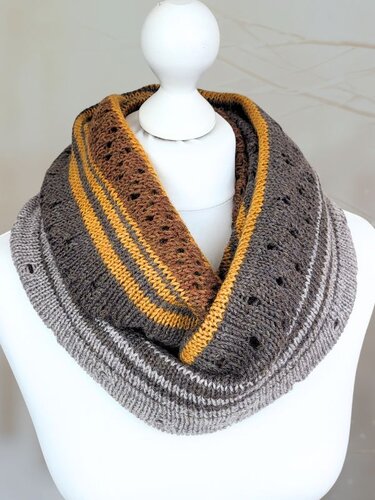 Gestrickter Loop-Schal in Grau, Braun und Senfgelb auf weißer Büste