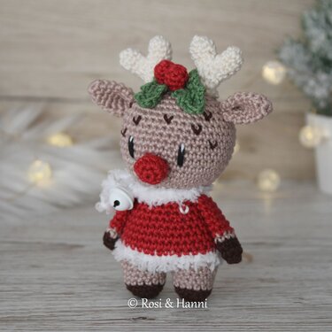 Gehäkeltes Rentier-Amigurumi in rotem Weihnachtskostüm mit roter Nase und Glöckchen