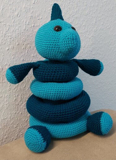 Gehäkelter Stapelturm in Dino-Form mit Ringen in Türkis und Dunkelblau