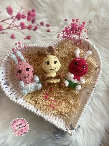 Kleines Trio schnell gehäkelter Amigurumi-Tiere in einer Herzschale