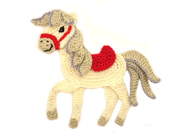 Cream crocheted horse applique with gray mane, red saddle and bridle
