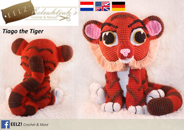 Nahaufnahme eines gehäkelten Tigerjunges in Rotbraun und Dunkelbraun, vorn und hinten auf hellem, flauschigem Untergrund.