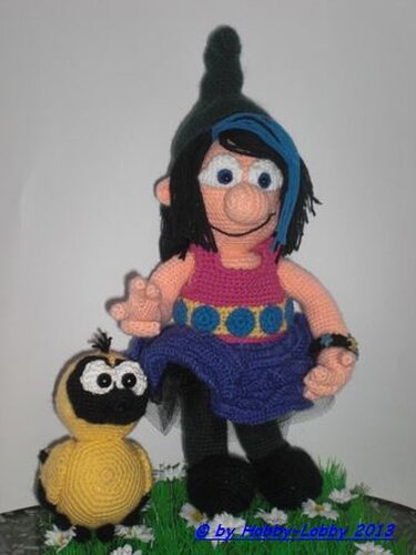 gehäkelte Hexenpuppe mit spitzem Hut und kleinem gelben Vogel