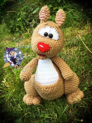 Braunes gehäkeltes Amigurumi-Känguru mit weißem Bauch und Beutel, sitzend