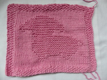 Rosa gestricktes Quadrat mit Hasenrelief und kraus rechtem Rand