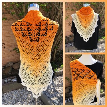 Gehäkeltes Dreieckstuch mit orange‑creme Farbverlauf und Blattspitzenmuster auf einer Schaufensterpuppe