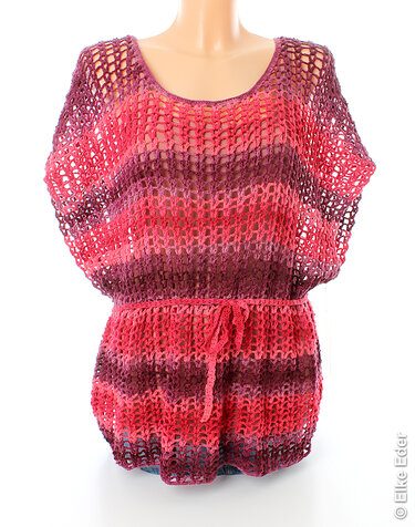 Openwork crocheted tunic top in pink, coral and plum stripes on a mannequin