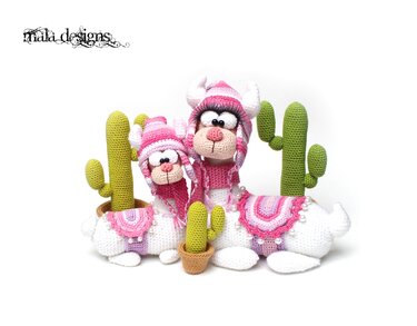 Two pink and white crocheted llama amigurumi with small crocheted cactus pots