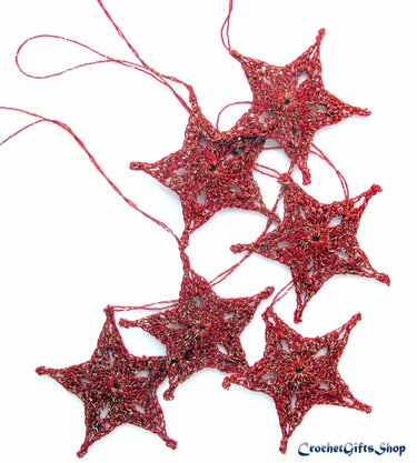 Red crocheted star garland with metallic thread, six stars strung together on a white background