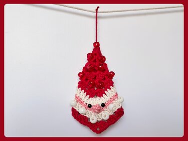 Compact granny-motif Santa crochet ornament in red and white with bead embellishments