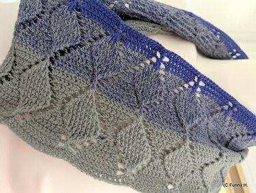 Gehäkelter Loop mit diamantförmigem Lochmuster in Grautönen und blauem Rand