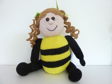 Gehäkeltes Amigurumi-Mädchen im gelb-schwarz gestreiften Bienenkostüm