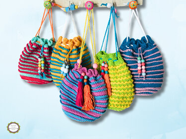 Colorful striped crocheted drawstring pouches with beads and tassels hanging on hooks