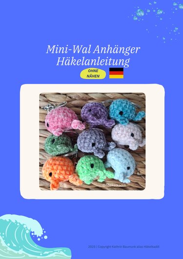 Neun bunte gehäkelte Mini-Wale mit Schlüsselringen auf geflochtener Unterlage