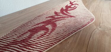 Narrow knitted shawl with red deer motif set in cream and red stripes