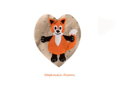 Orange fox fabric appliqué on a speckled beige heart-shaped patch.