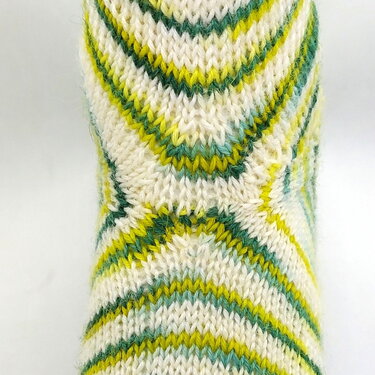 Gestrickter Sockenabsatz mit Chevron-Muster in Weiß, Grün und Gelb
