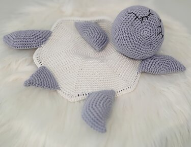 Pastel crochet turtle lovey with white hex blanket and lilac head and limbs