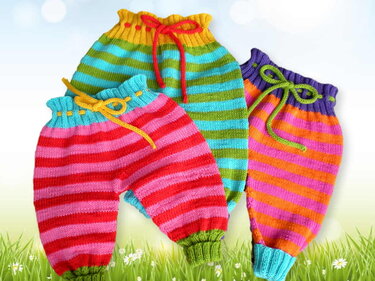 Three colorful striped knitted baby pants with ribbed ankle cuffs and drawstring waists on a light background