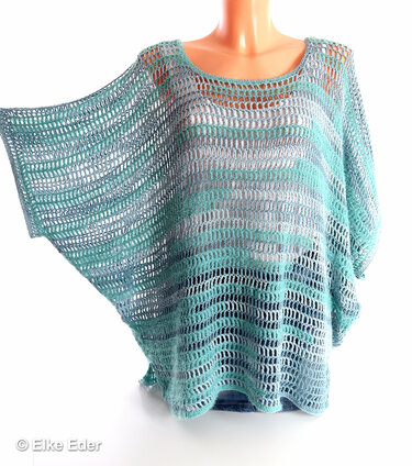 Light blue and teal striped open-knit crochet tunic on a mannequin