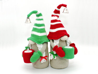 Two crocheted gnome bottle covers with striped hats, bell accents and candle sleeves