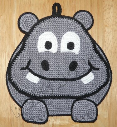 Gehäkelter grauer Nilpferd-Topflappen mit schwarzer Umrandung, weißen Augen und Aufhängeschlaufe