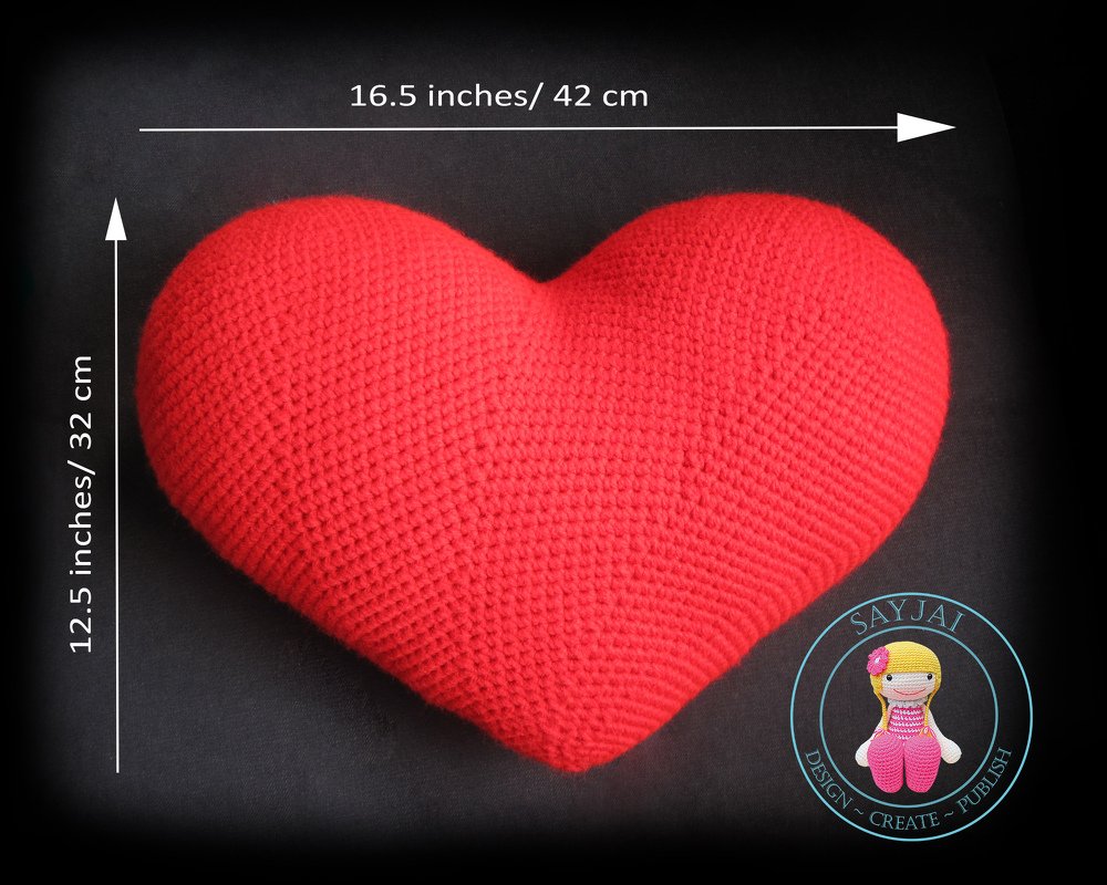 Red crocheted heart-shaped pillow on a dark background, 16.5 x 12.5 inches