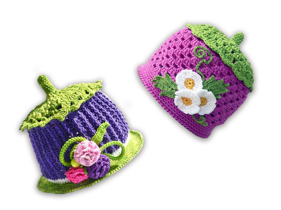 Verspielte gehäkelte Babymützen in Pink und Violett mit grünen Blatträndern und Blumen