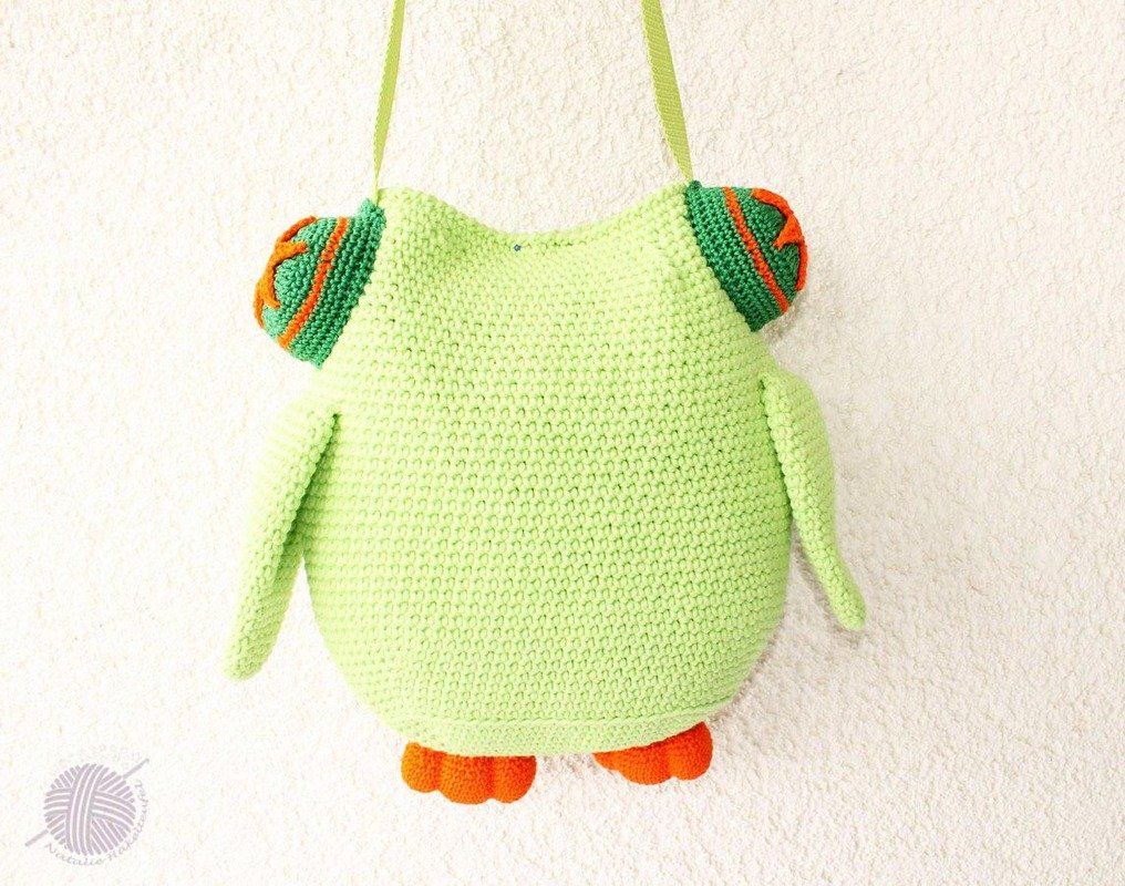 Light green crocheted owl shoulder bag with orange feet and ear accents