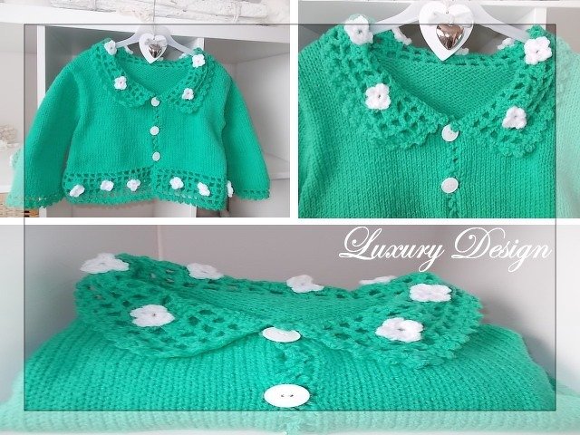 Kurz geschnittene grüne Strickjacke für Kinder mit gehäkelter Kante, weißen Blüten und Knöpfen