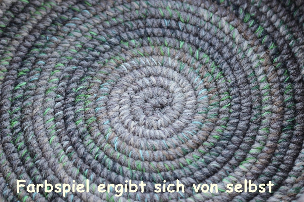 Macro view of stitch detail on round crochet basket base with variegated yarn