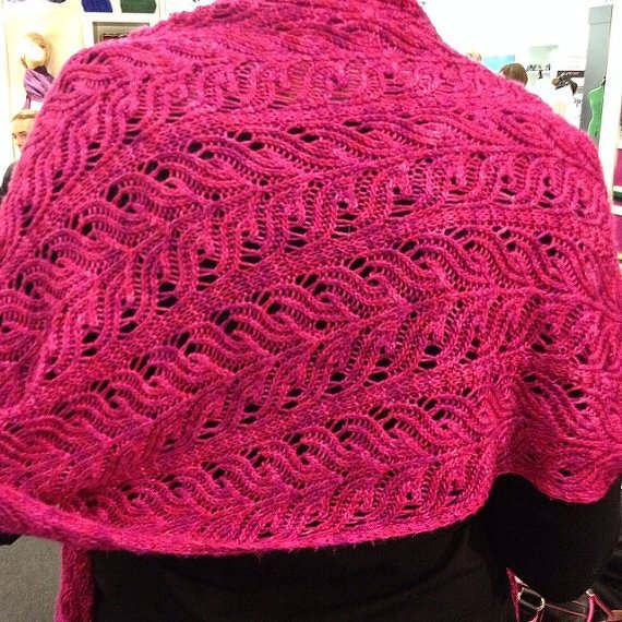 Magenta gestricktes Lacetuch mit Blatt-Ajourmuster über den Schultern